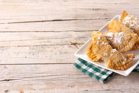 Spanish sweet stuffed pastry filled with angel hair on wooden tableの写真素材