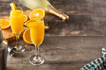 Orange mimosa cocktail on wooden tableの写真素材