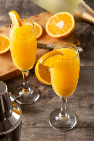 Orange mimosa cocktail on wooden tableの写真素材