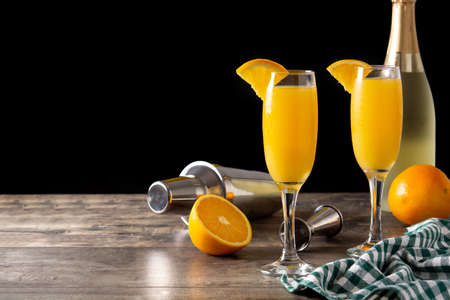 Orange mimosa cocktail on wooden tableの写真素材
