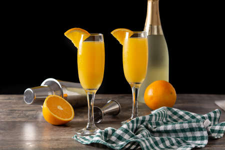 Orange mimosa cocktail on wooden tableの写真素材
