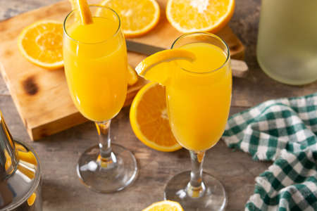 Orange mimosa cocktail on wooden tableの写真素材
