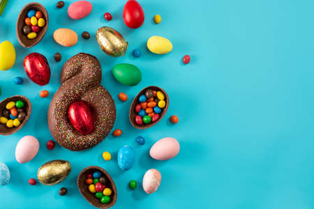 Mona de pascua cake and Easter eggs on blue background
