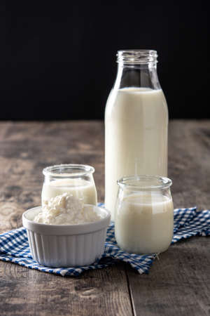 Milk kefir drink on wooden table. Liquid and fermented milk product on wooden table