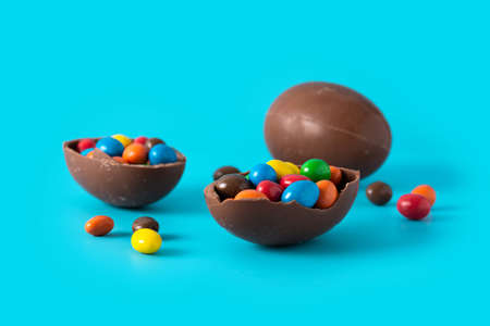 Colorful chocolate Easter eggs on blue background