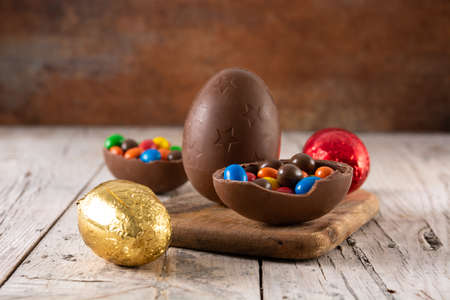 Colorful chocolate Easter eggs on wooden table