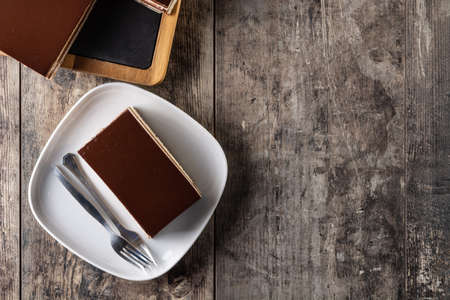 Opera cake dessert on wooden table