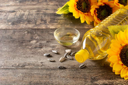 Sunflower oil plastic bottle on wooden tableの写真素材