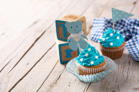 Blue cupcake for baby shower on wooden tableの写真素材