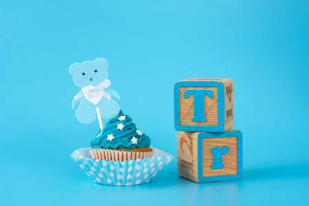 Blue cupcake for baby shower on blue backgroundの写真素材