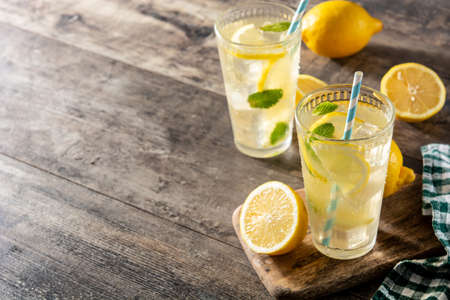 Glass of fresh lemonade on wooden tableの写真素材