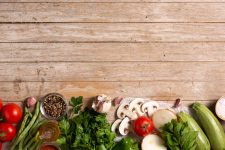 Assortment of vegetables, herbs and spices on wooden tableの写真素材