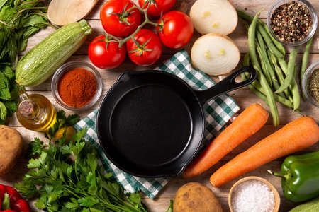 Assortment of vegetables, herbs and spices on wooden tableの写真素材