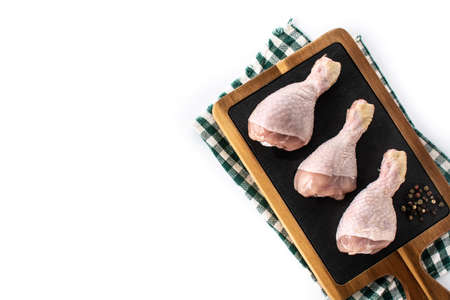 Raw chicken meat legs on cutting board isolated on white backgroundの写真素材
