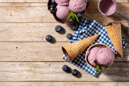 Blueberry ice cream scoops on wooden tableの写真素材