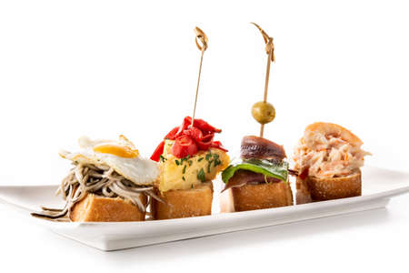 Assortment of Spanish pintxos on wooden table. typical spanish foodの写真素材