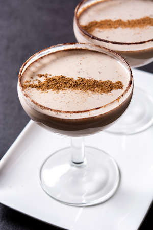 Brandy Alexander cocktail on black slate background