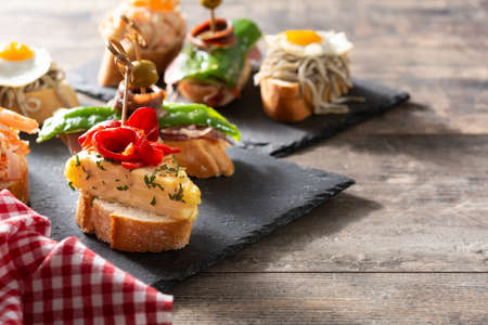 Assortment of Spanish pintxos on wooden table