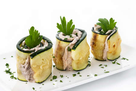 Grilled zucchini rolls with tuna and cream cheese isolated on white backgroundの写真素材
