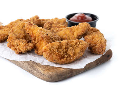 Crispy Kentucky fried chicken on cutting board isolated on white backgroundの写真素材