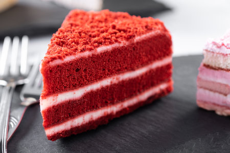 Set of cake portions, velvet, strawberry cake, carrot cake and chocolate cake on marbleの写真素材