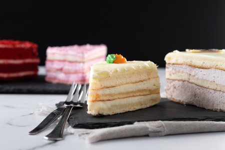 Set of cake portions, velvet, strawberry cake, carrot cake and chocolate cake on marble.の写真素材