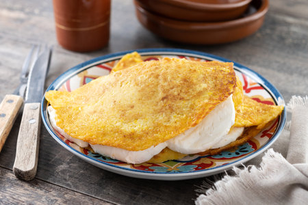 Traditional Venezuelan beef cachapa on wooden tableの写真素材
