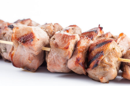 Grilled chicken meat skewer isolated on white backgroundの素材