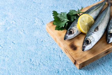 Raw mackerel fish salt around on blue backgroundの写真素材