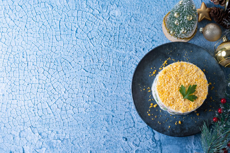 Russian salad or Olivier salad for Christmas dinner on blue backgroundの写真素材