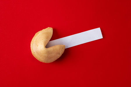 Traditional fortune cookie on red backgroundの写真素材