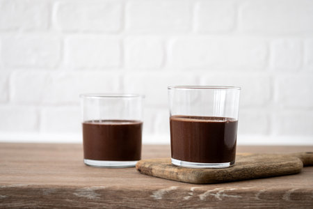 Chocolate mousse dessert garnished with mint leaf on wooden tableの写真素材