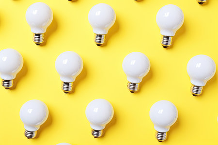 white bulbs pattern on yellow background. winning ideas conceptの素材