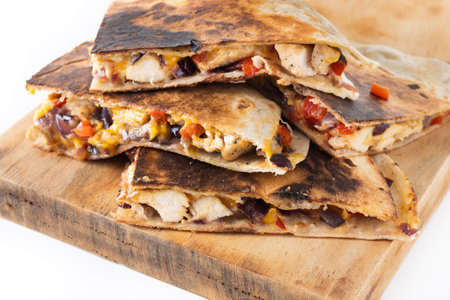 Mexican quesadilla with chicken, cheese and peppers isolated on white backgroundの写真素材
