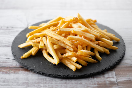 Fried potatoes, french fries on wooden tableの写真素材