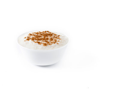 Rice pudding. Rice pudding with cinnamon in clay bowl isolated on white backgroundの写真素材