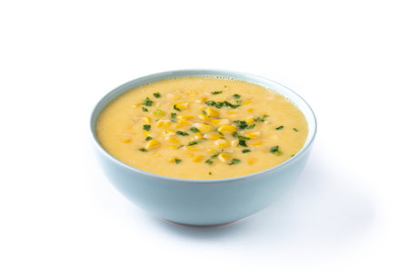 Corn soup in white bowl isolated on white backgroundの写真素材