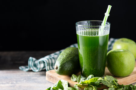 Green smoothie detox with Kale, avocado and apples on wooden tableの写真素材