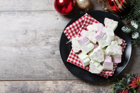 Christmas marshmallow and Christmas decoration on wooden tableの写真素材