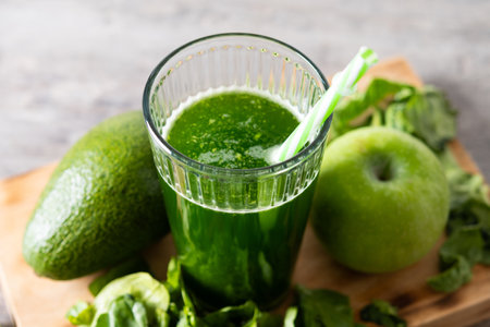 Green smoothie detox with Kale, avocado and apples on wooden tableの写真素材