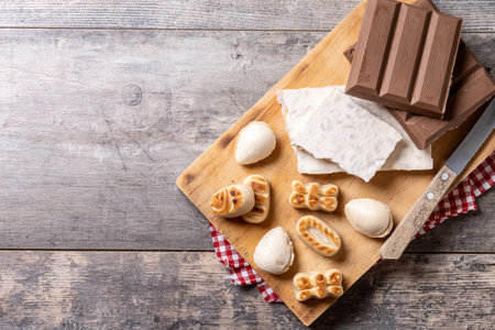 Traditional Christmas sweet, nougat and Christmas sweet almonds on wooden tableの写真素材