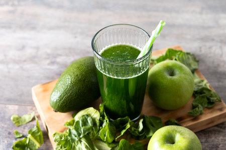 Green smoothie detox with Kale, avocado and apples on wooden tableの写真素材