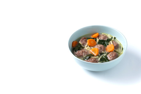 Italian Wedding Soup with meatballs and spinach isolated on white backgroundの写真素材