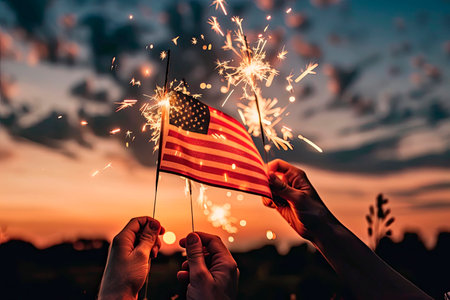 hands waving american flags for the 4th of julyの素材