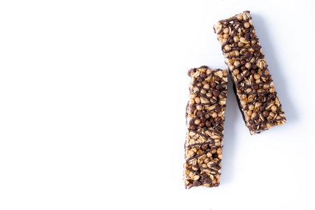 Healthy Muesli bars with nuts and black chocolate isolated on white backgroundの写真素材