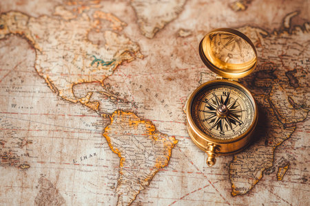 Magnetic old compass on world map. Concept of travel, tourism and adventureの素材