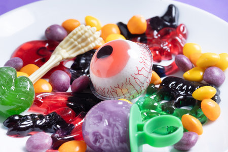 Assortment of Halloween candies with colorful backgroundの写真素材