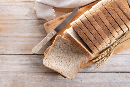 Healthy wholemeal bread slices on rustic wooden table