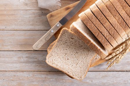 Healthy wholemeal bread slices on rustic wooden table