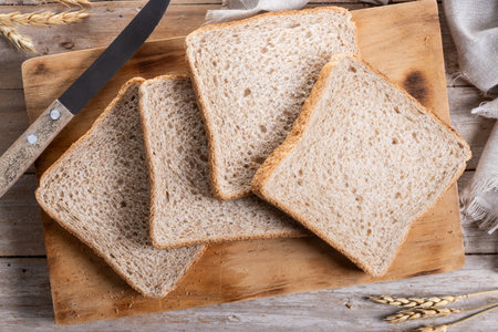 Healthy wholemeal bread slices on wooden tableの写真素材
